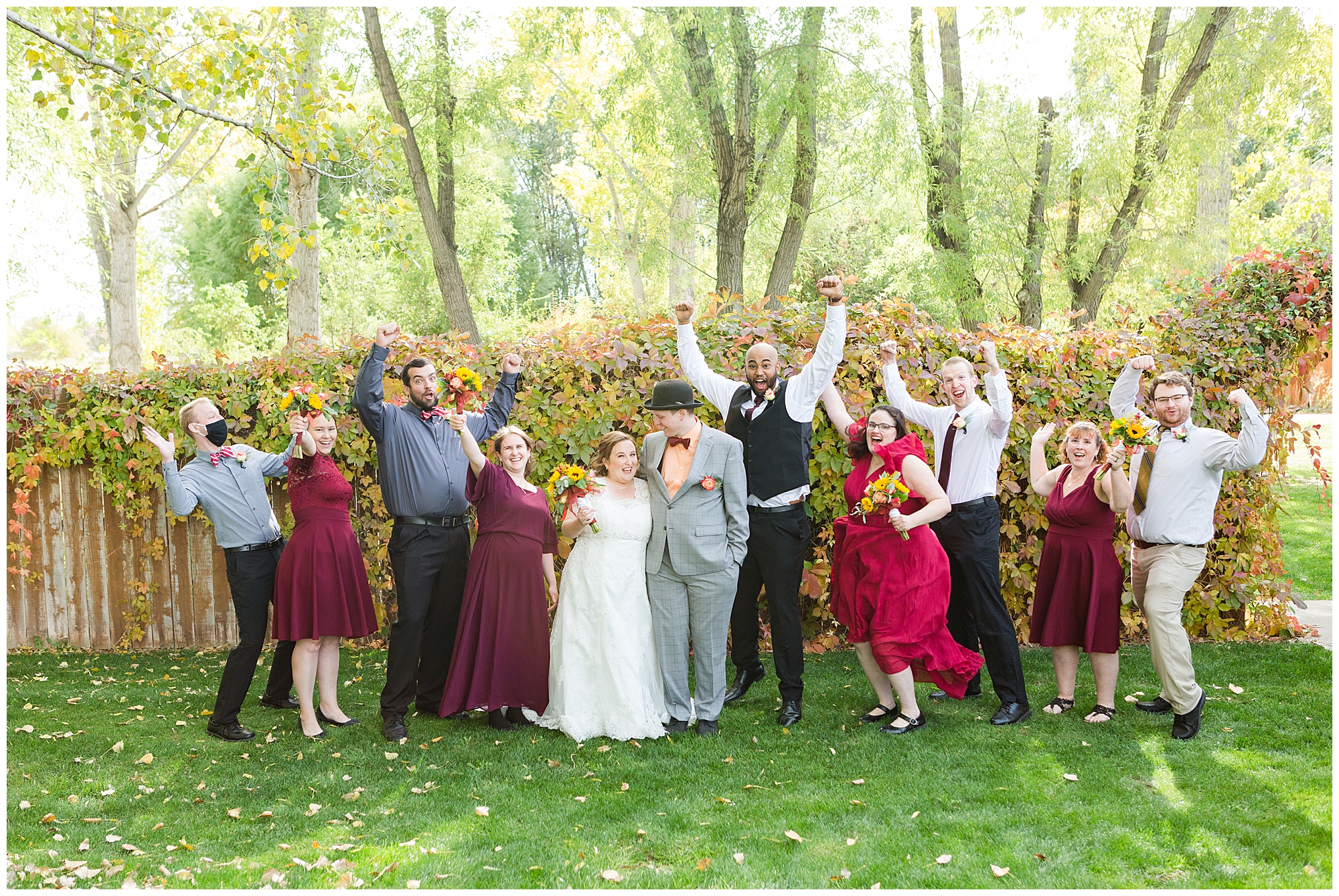 The wedding party cheering at an outdoor fall wedding in Nampa