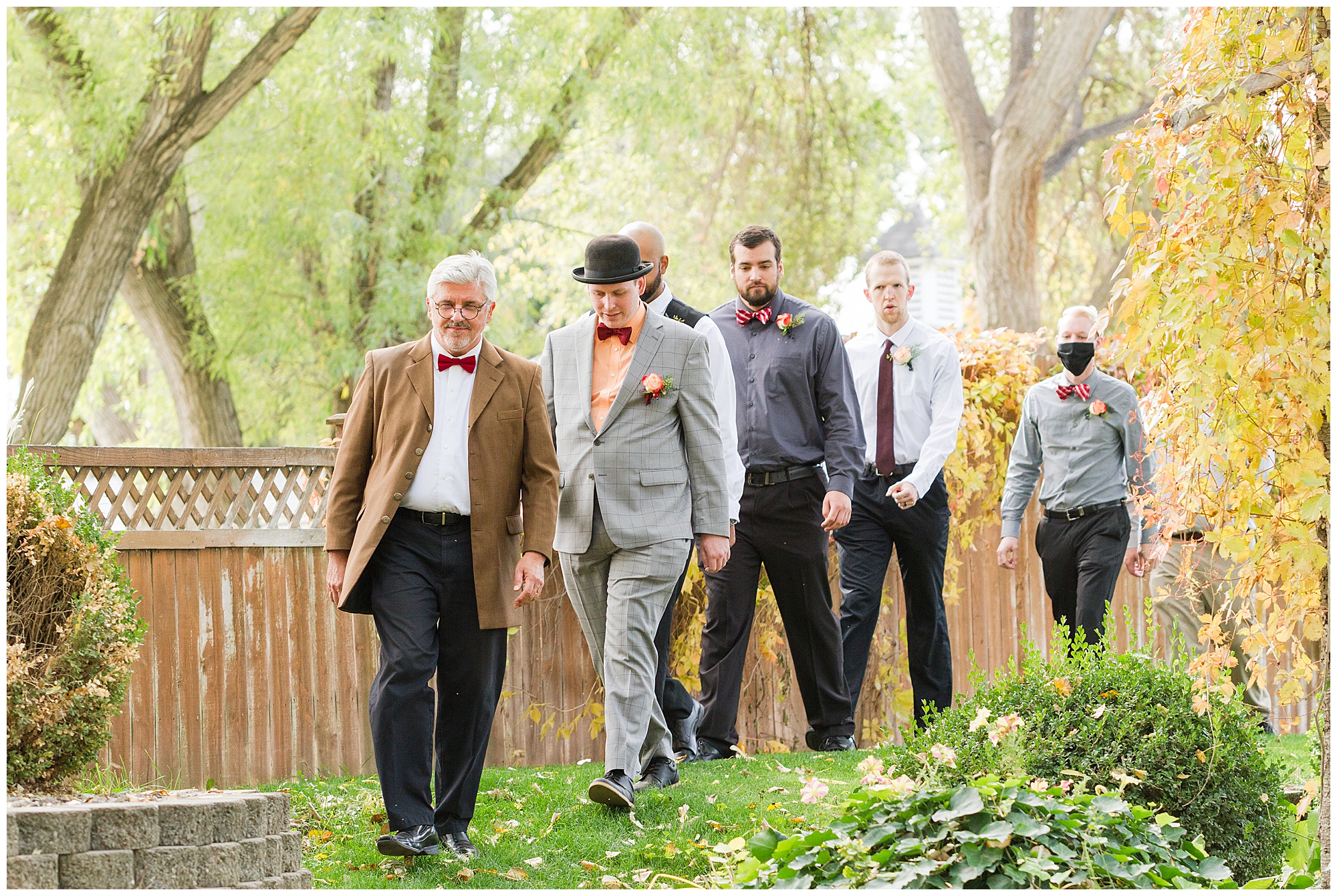 The officiant, groom, and groomsmen enter the amphitheater at the start of the ceremony