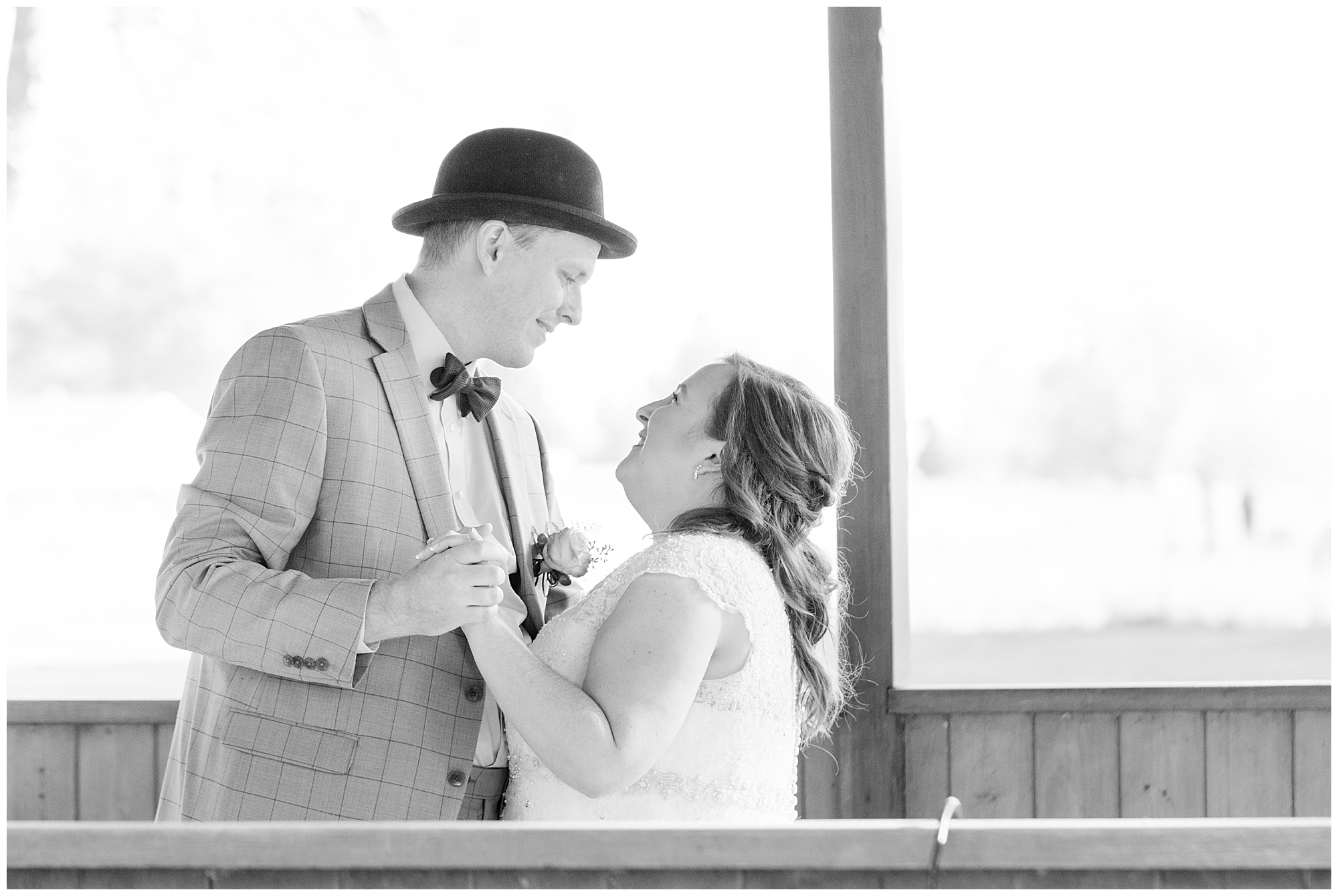 Bride and groom smiling at each other during their first dance