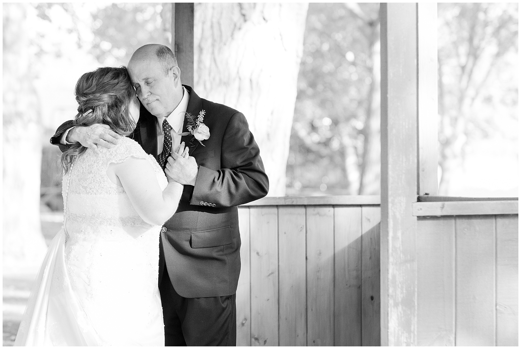 The bride and her father share a tender moment during the father-daughter dance