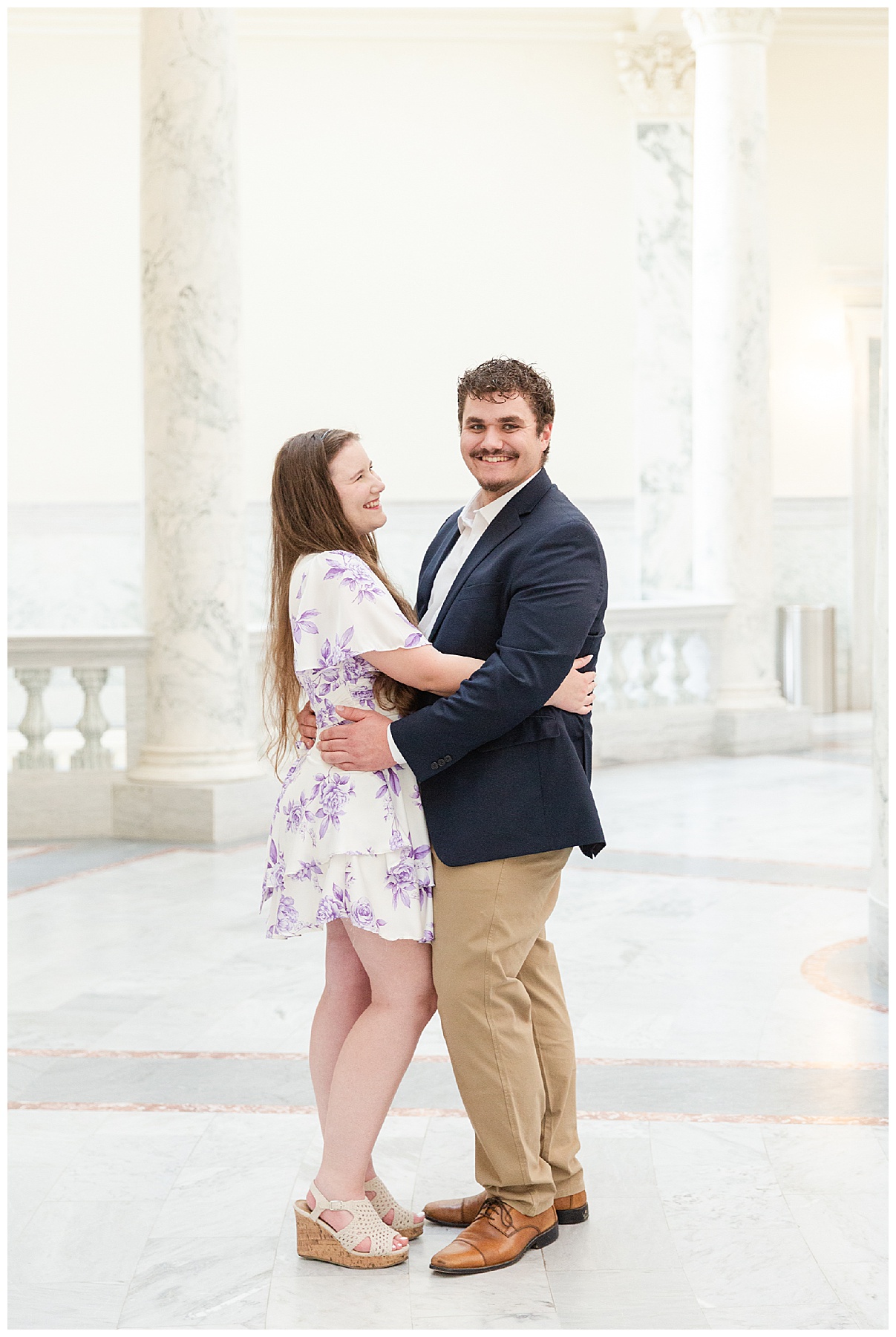The bride-to-be smiling at her future groom during their engagement photos session