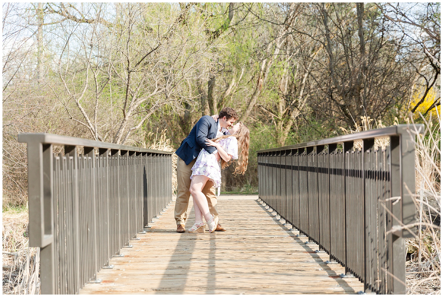 A couple doing a dip kiss on a bride at Kathryn Albertson Park in Boise