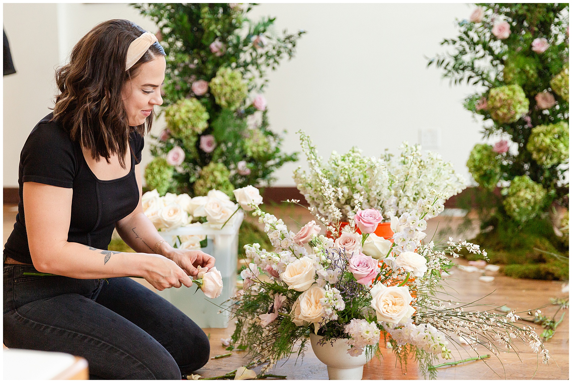 The florist puts the finishing touches on an arrangement