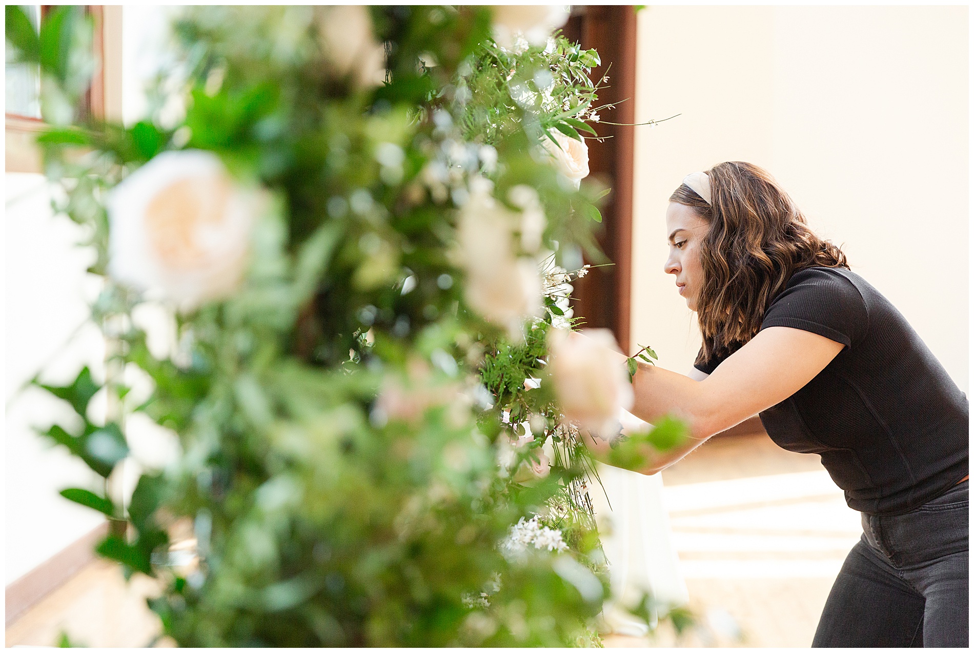 The florist puts the finishing touches on a large arrangement