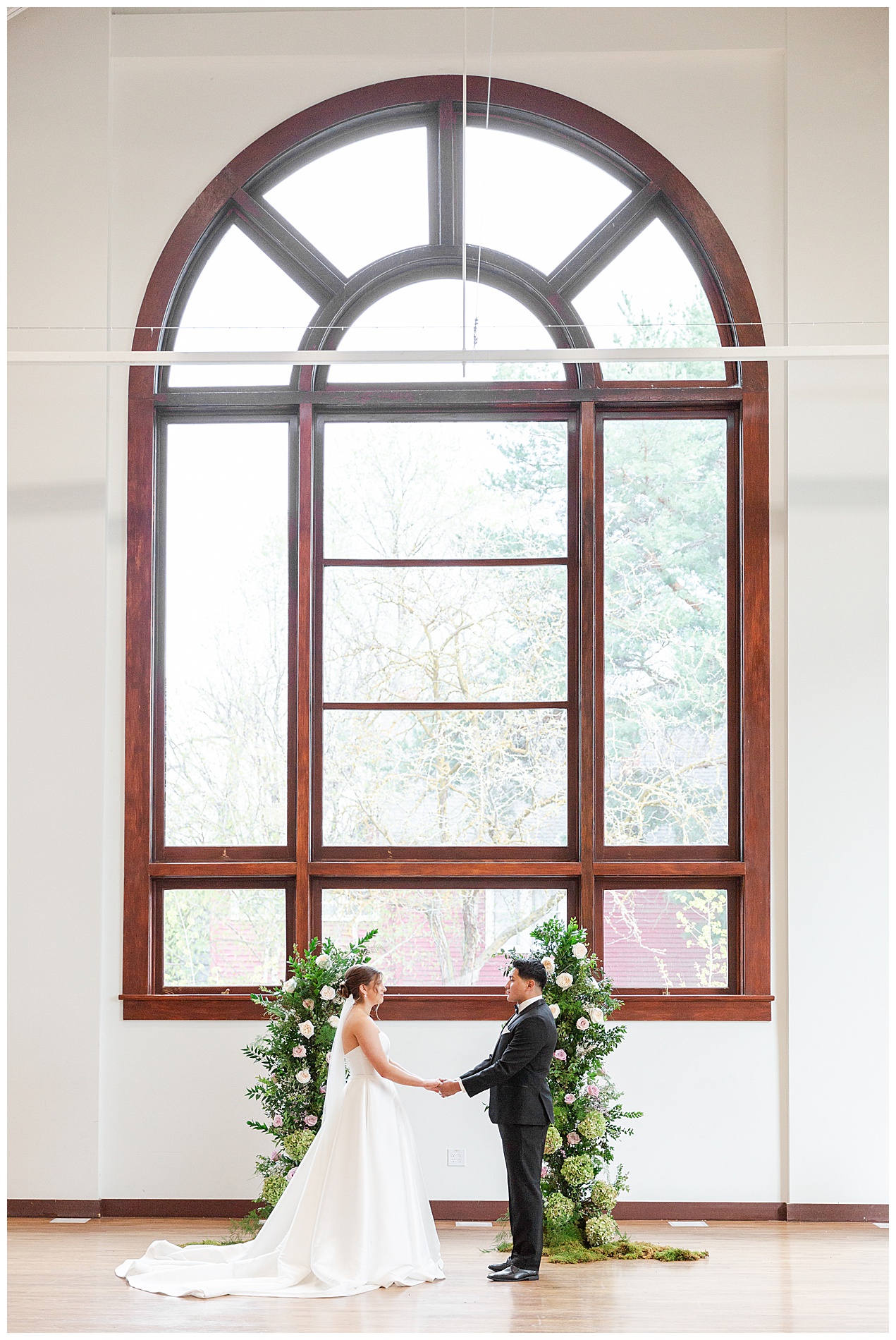 The couple hold hands and make their vows during the ceremony