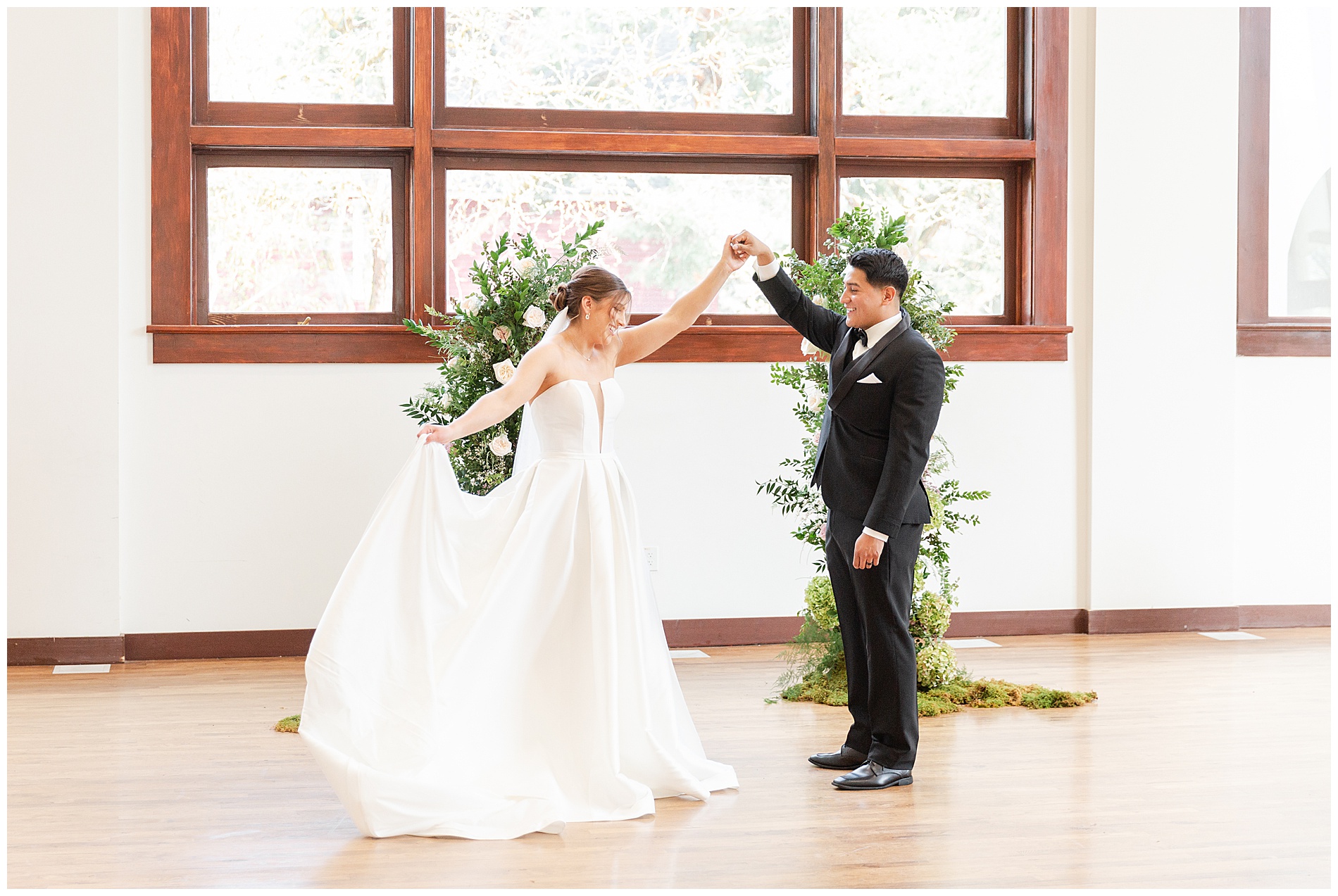 The bride shows off her dress to the groom