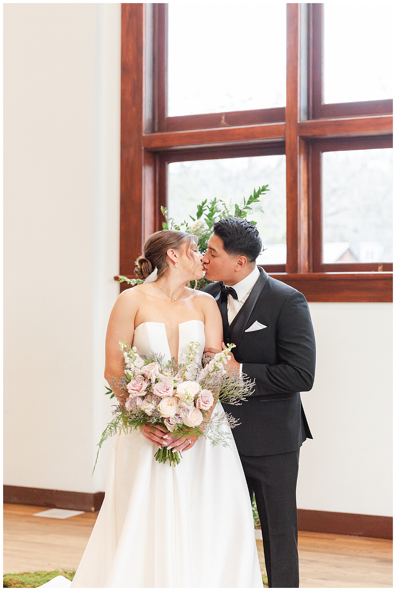 The bride and groom kiss after their ceremony