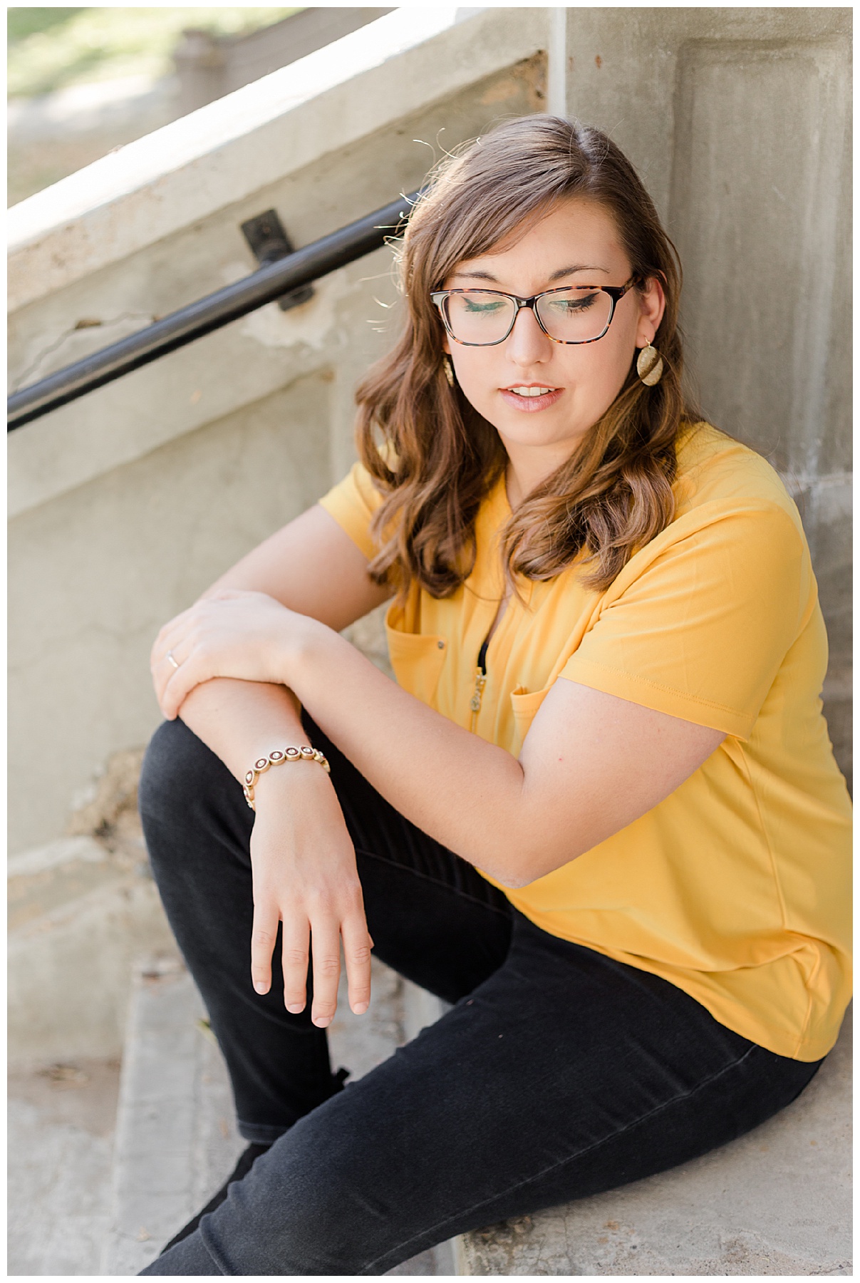 Senior girl in golden yellow top sitting on stone steps in Weiser, Idaho