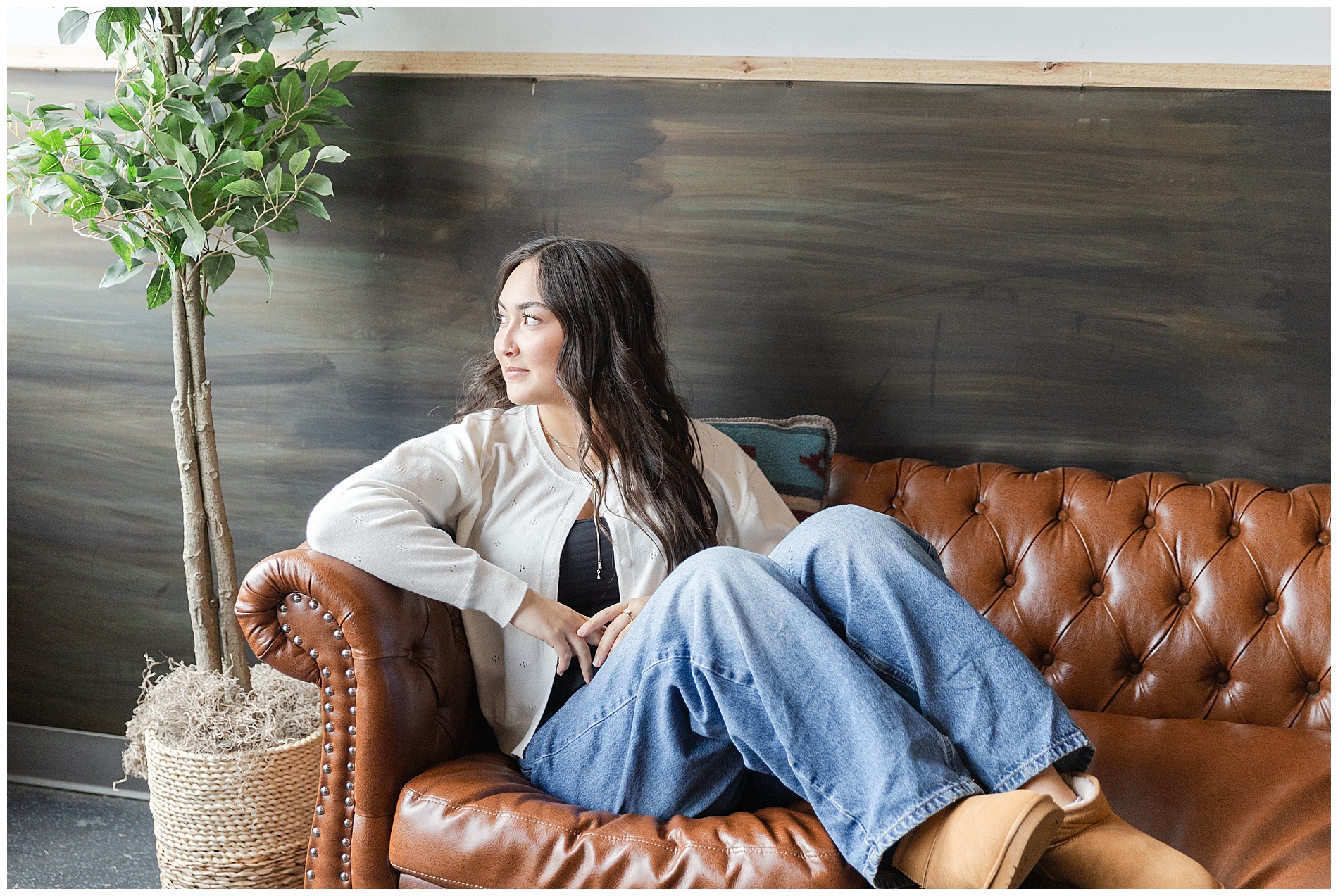 Senior girl sitting on a couch inside Pioneer Lodge