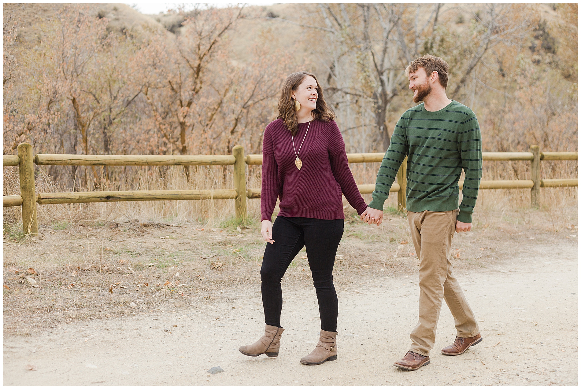 Fall engagement photos with a wooden fence in Boise's Military Reserve