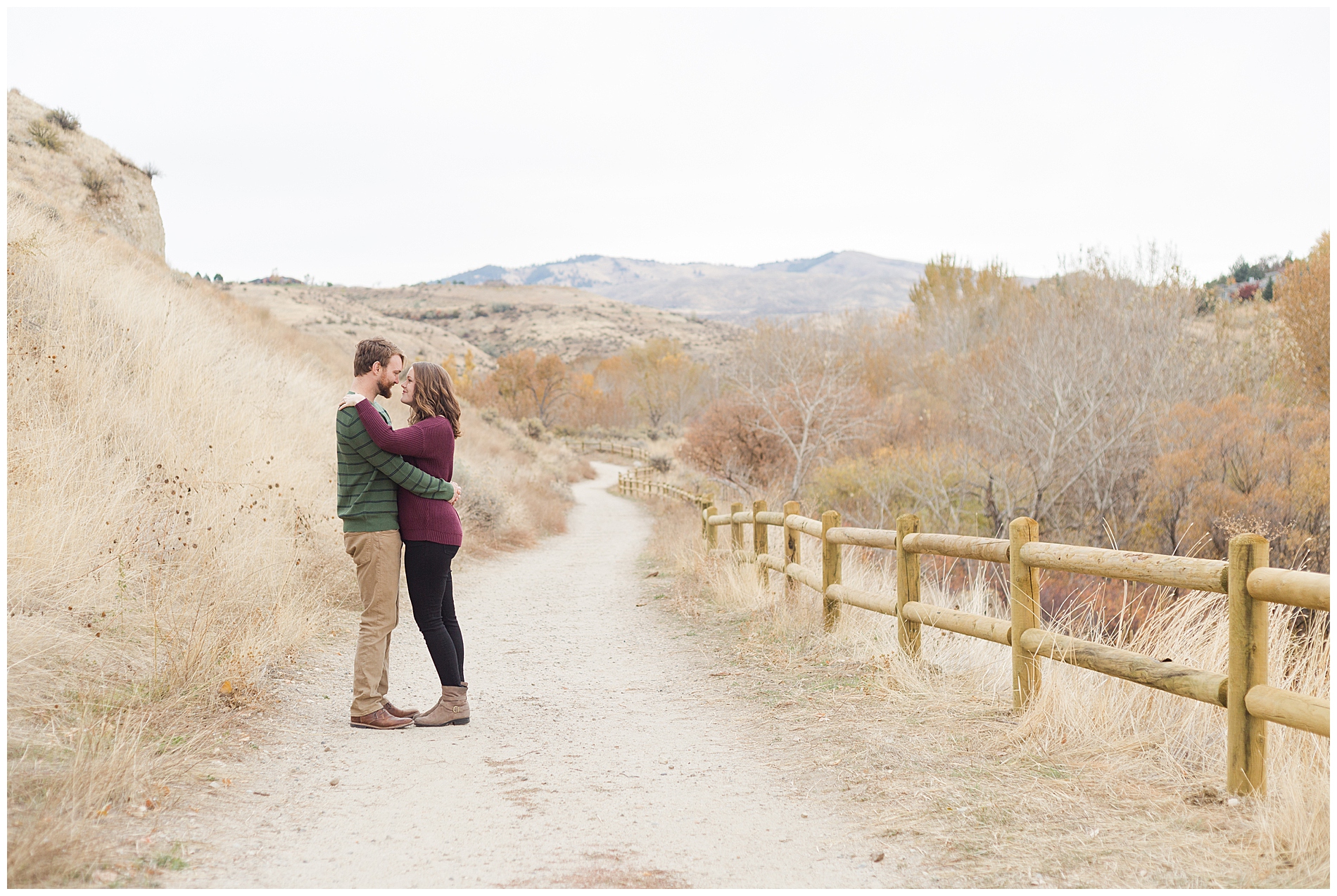 Fall engagement photos with a wooden fence at the Military Reserve park in Boise