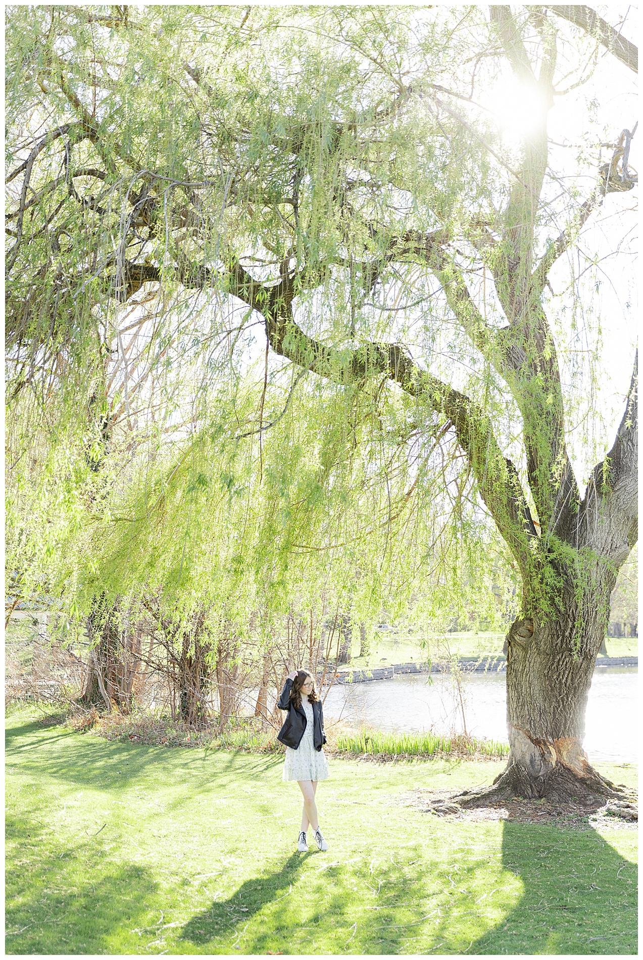 Girl standing under a large willow tree at Julia Davis Park