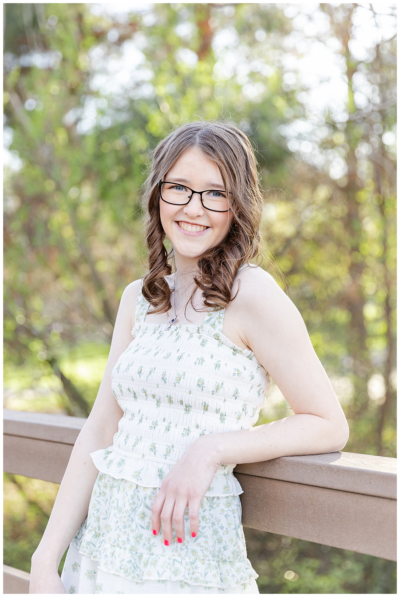Girl in a sundress leaning on a railing close to the Discovery Center in downtown Boise