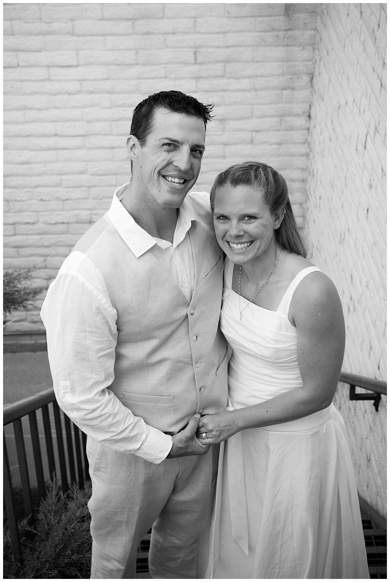 Bride and groom holding hands on a church stairway