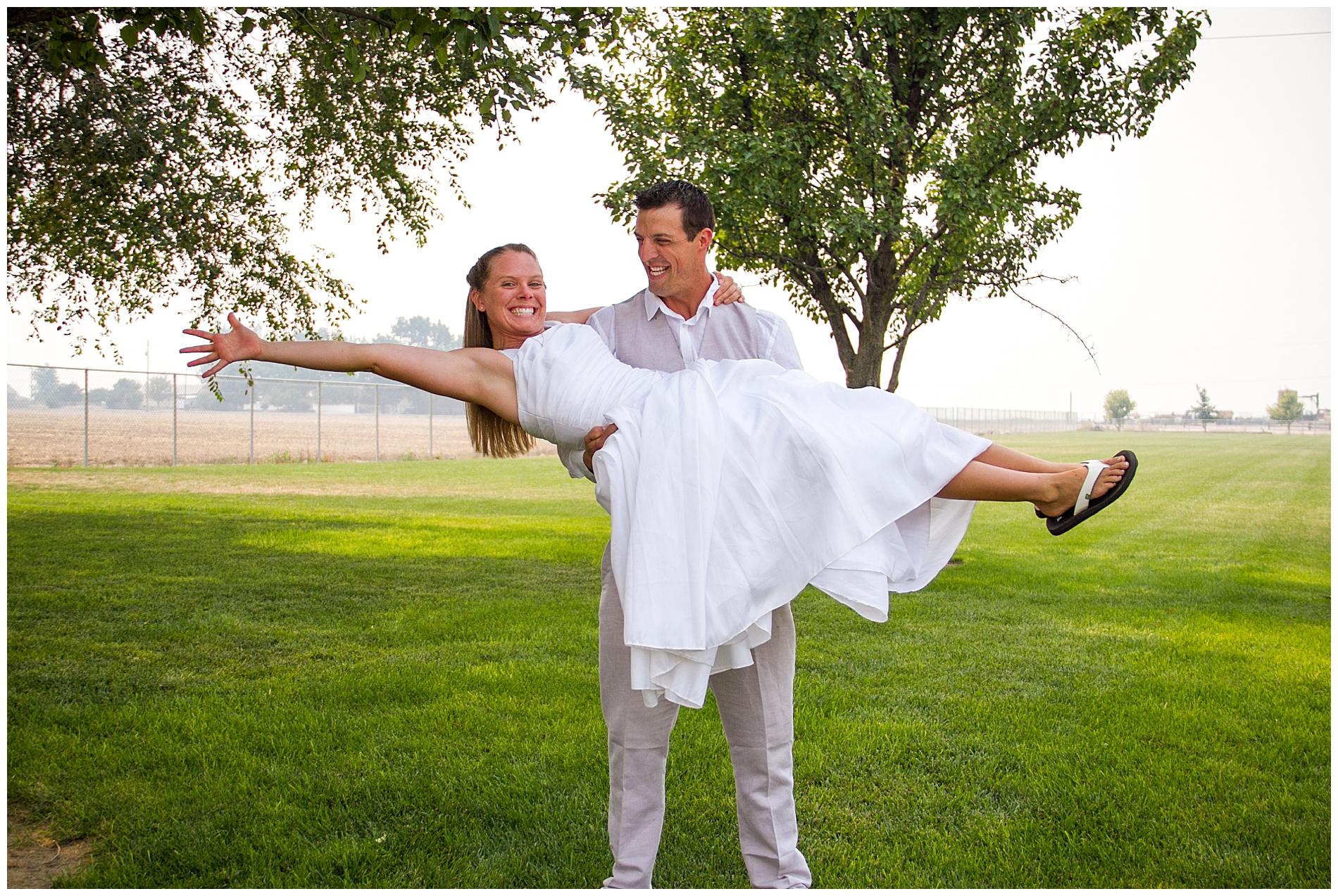 A groom picks up his bride at their wedding in eastern Oregon