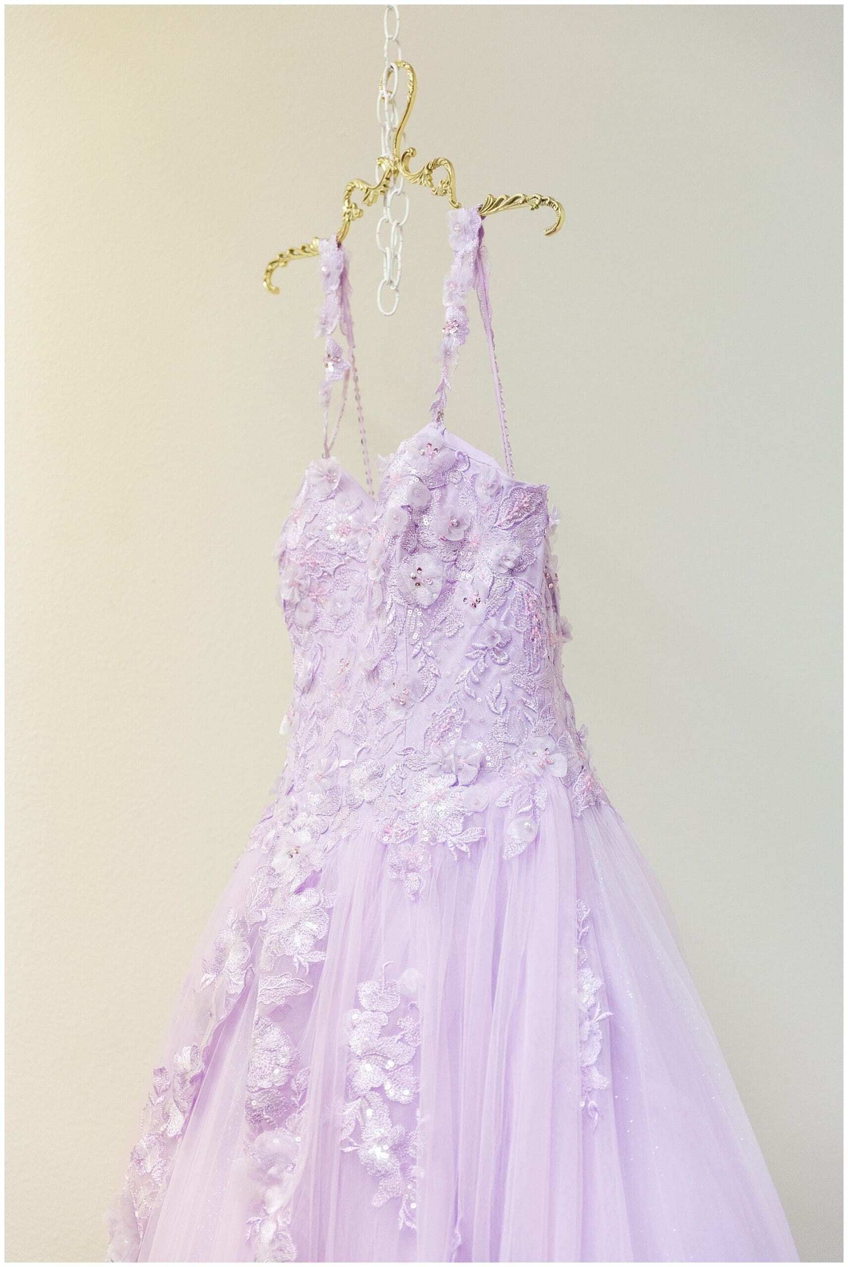 Quinceañera gown hanging from a hanger before the ceremony