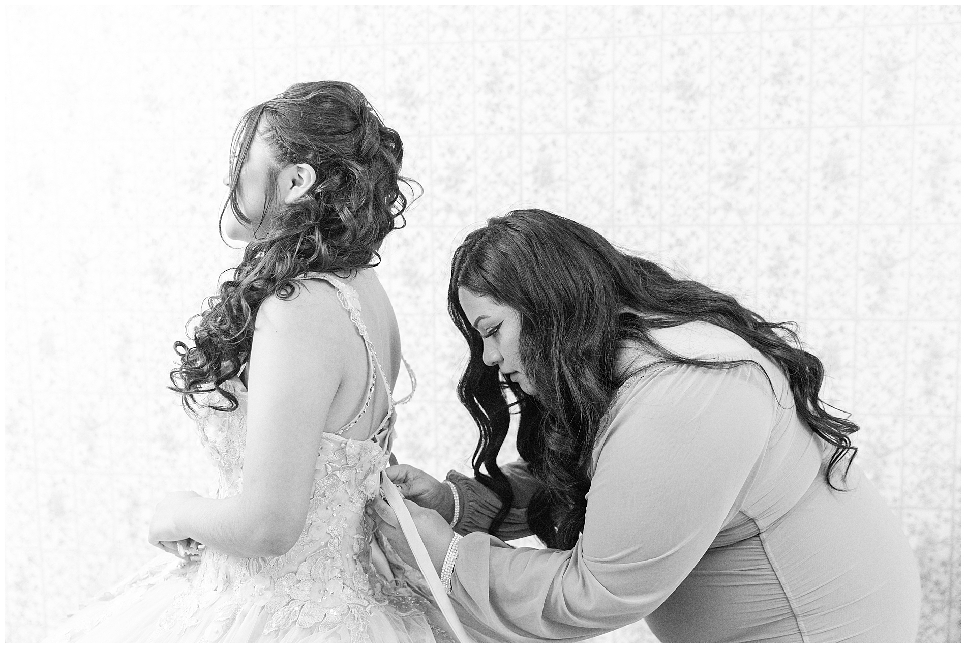 Ana gets help with lacing up the back of her dress