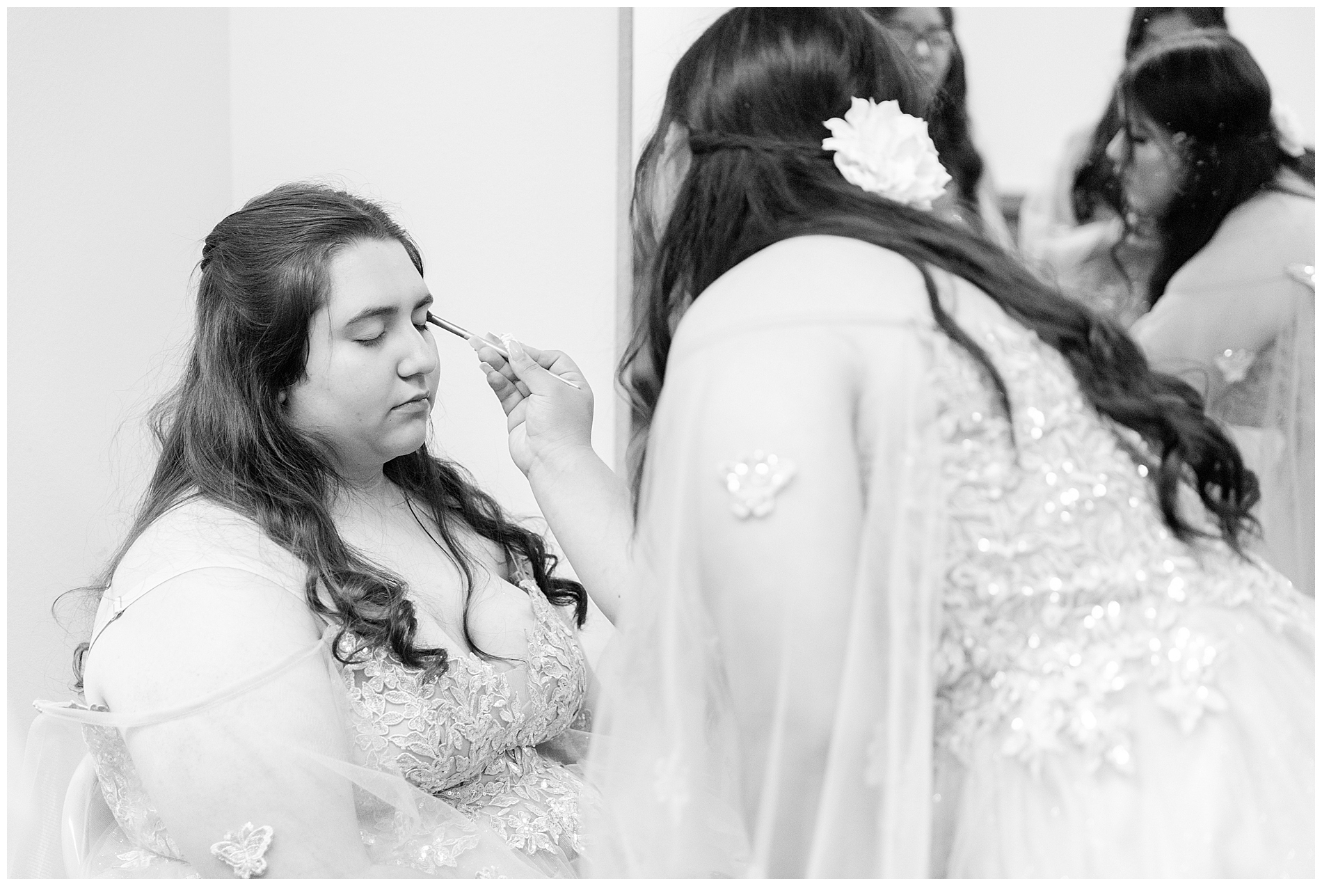 Applying makeup before the quinceañera ceremony