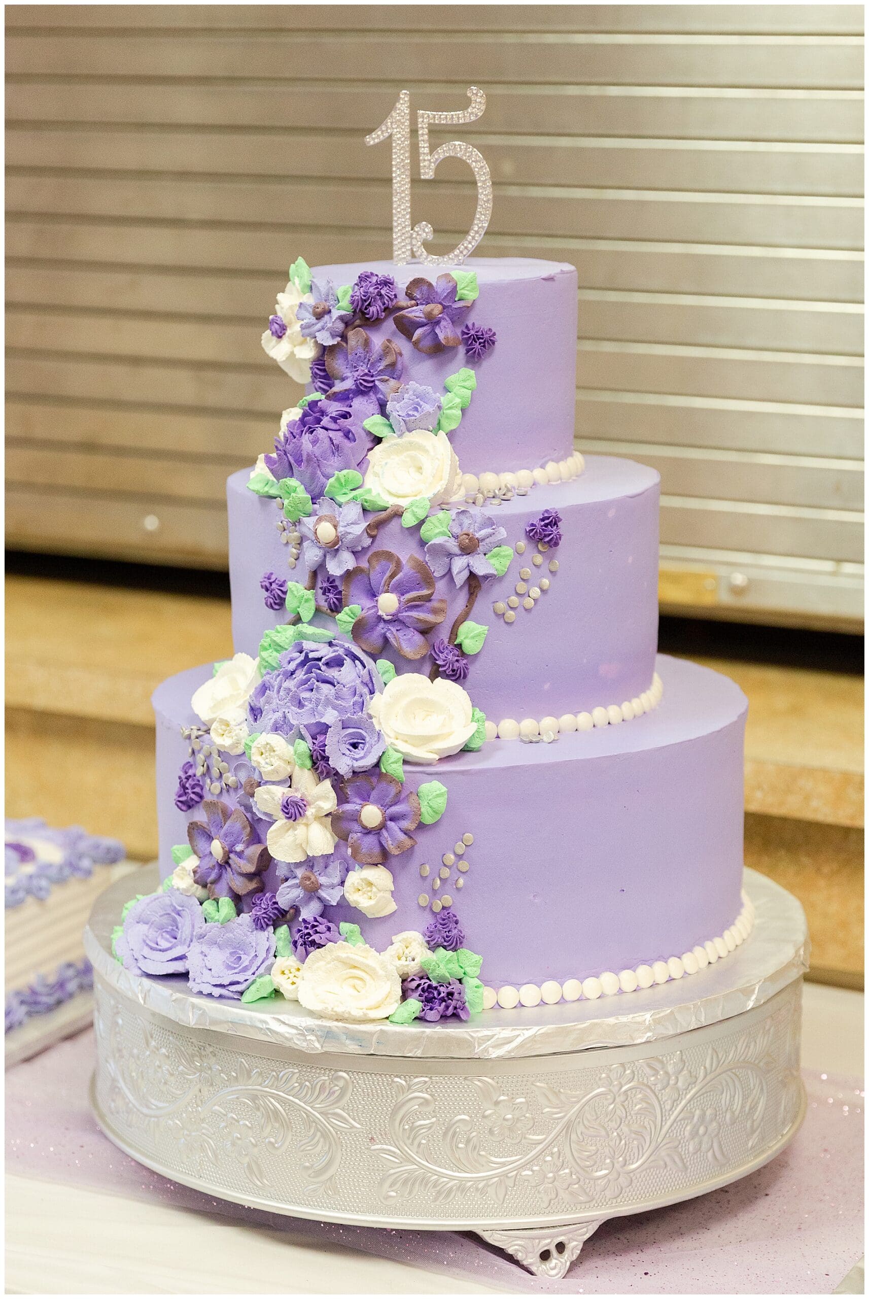 The purple cake with its "15" topper and frosting flowers cascading down